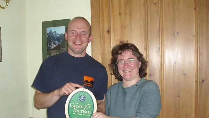 a man and a woman holding a frisbee at Fraoch Lodge in Boat of Garten