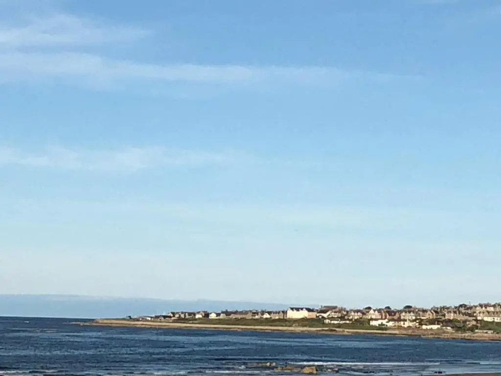 a large body of water with houses in the background at Ballies Retreat in Lossiemouth