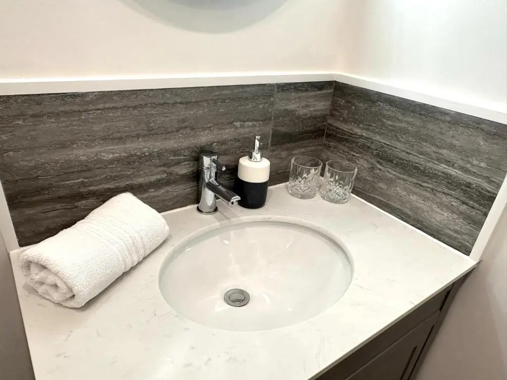 a white sink in a bathroom with a counter at Beechtree Cottage, Cairngorm Suite, Kirkmichael in Blairgowrie