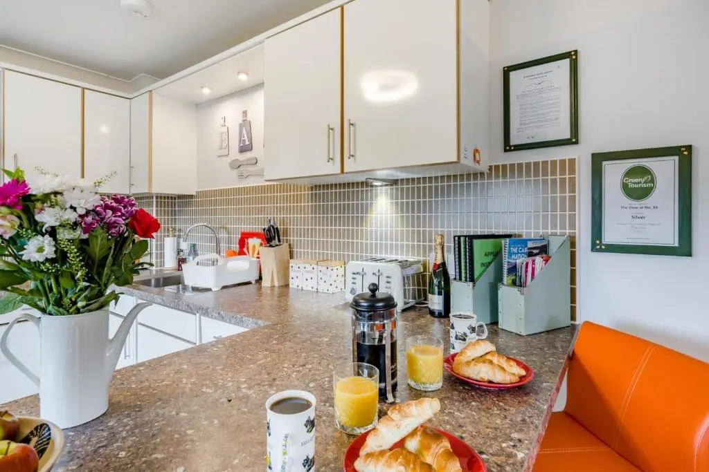a kitchen with a counter with bread and orange juice at 2 Bed in Aviemore oc-t30584 in Aviemore
