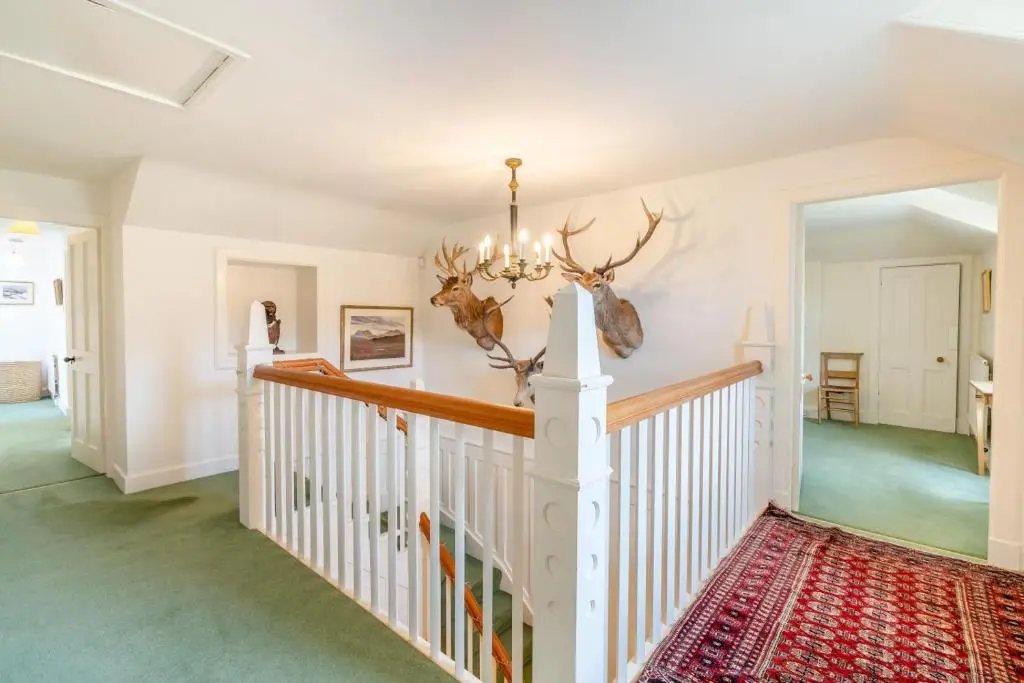 a foyer with a white staircase and a chandelier at 7 Bed in Strathdon oc-t30594 in Strathdon