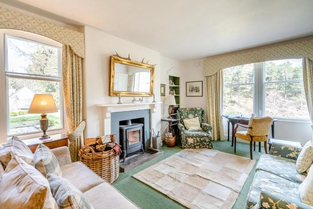 a living room with a couch and a fireplace at 7 Bed in Strathdon oc-t30594 in Strathdon