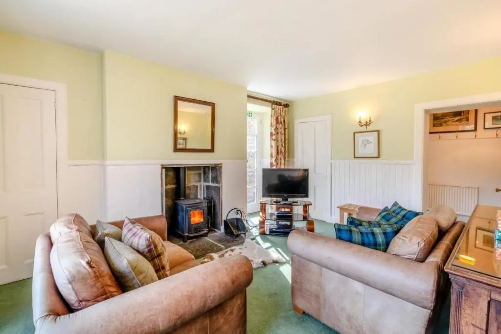 a living room with two couches and a fireplace at 7 Bed in Strathdon oc-t30594 in Strathdon