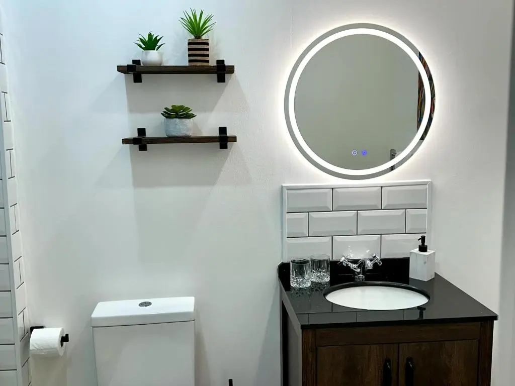 a bathroom with a sink and a mirror at Beechtree Cottage, Ardle Family Room, Kirkmichael in Kirkmichael