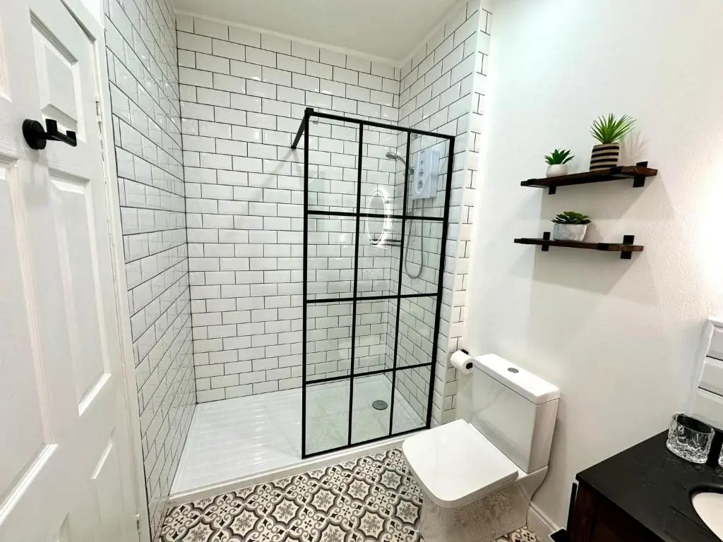a white bathroom with a shower with a toilet at Beechtree Cottage, Ardle Family Room, Kirkmichael in Kirkmichael