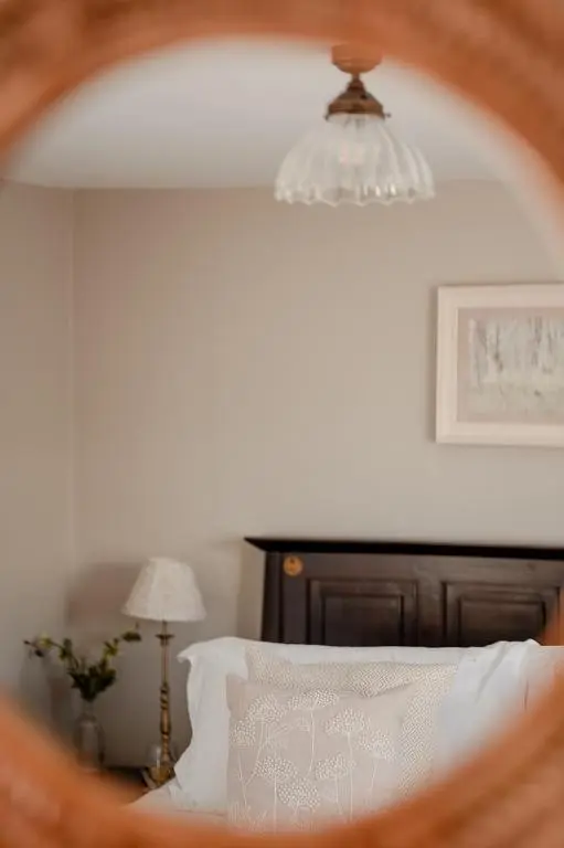 a bedroom with a bed with a chandelier at Park Cottage - Seasgair Lodges in Kingussie