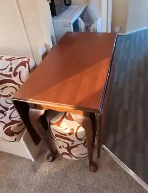 a wooden coffee table sitting next to a couch at Aurora on the Dunes- Cozy Coastal Retreat with Scenic Views in Lossiemouth