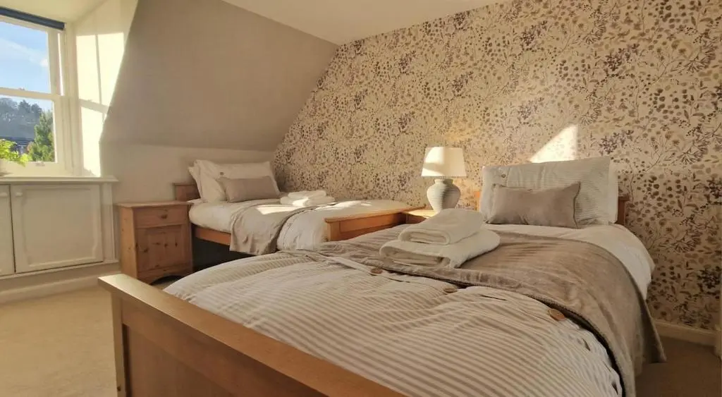 a bedroom with two beds and a window at North Coast Property - Avoch Beach House - Luxury house with sea views in Avoch