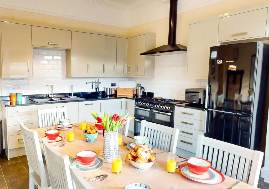 a kitchen with a table with food on it at Schoolhouse in Laggan