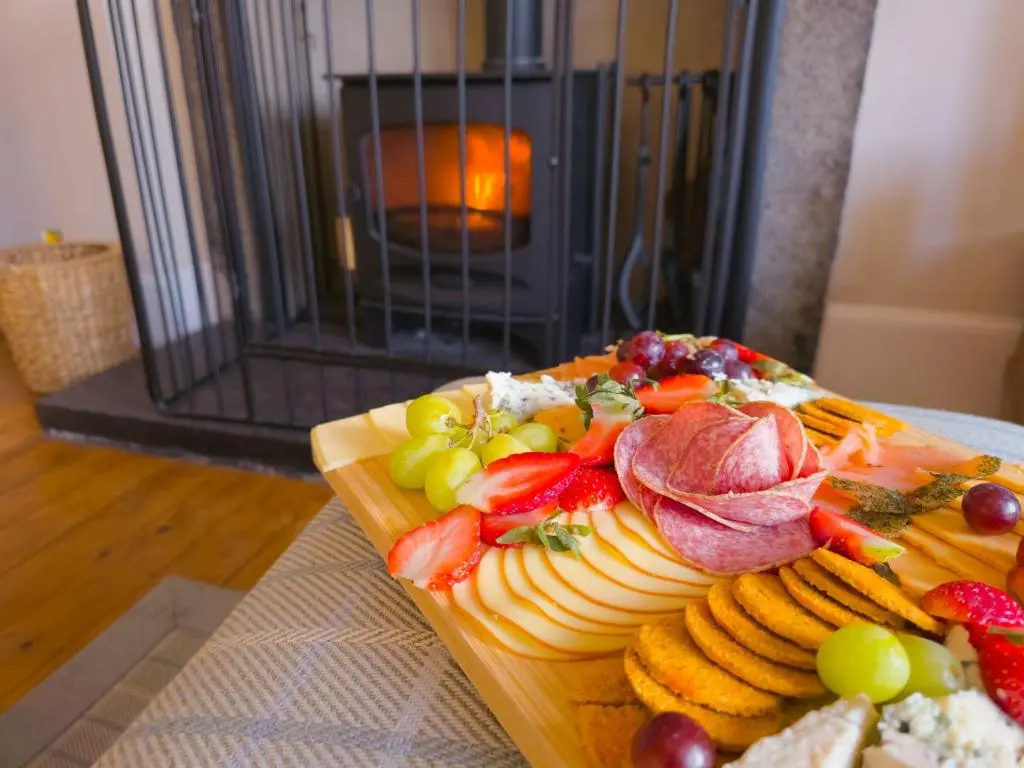a plate of food with meat and fruit on a table at Schoolhouse in Laggan