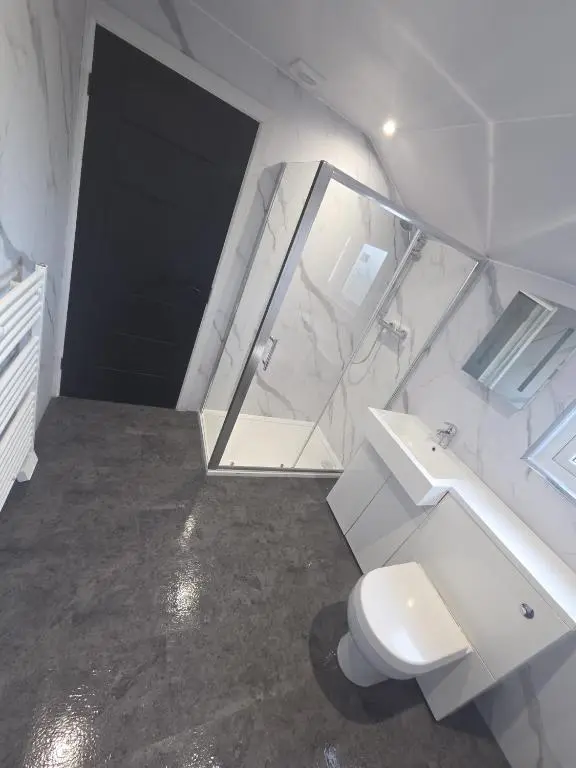 a white bathroom with a toilet and a sink at Woodside House in Crook of Alves