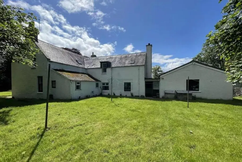an old white house with a large yard at Woodside House in Crook of Alves