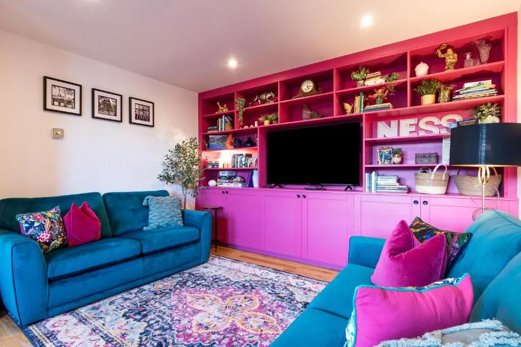 a living room with a couch and a tv at Ness in the City in Inverness