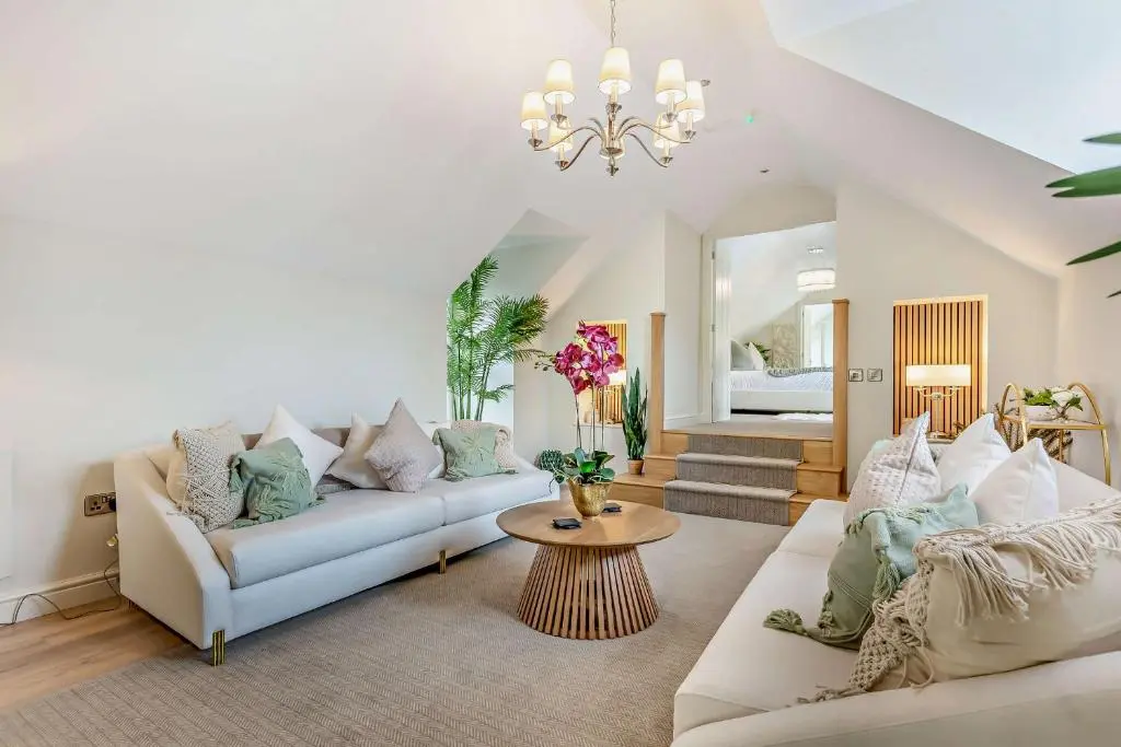 a living room with two couches and a table at Cairngorm Cottage in Skye of Curr