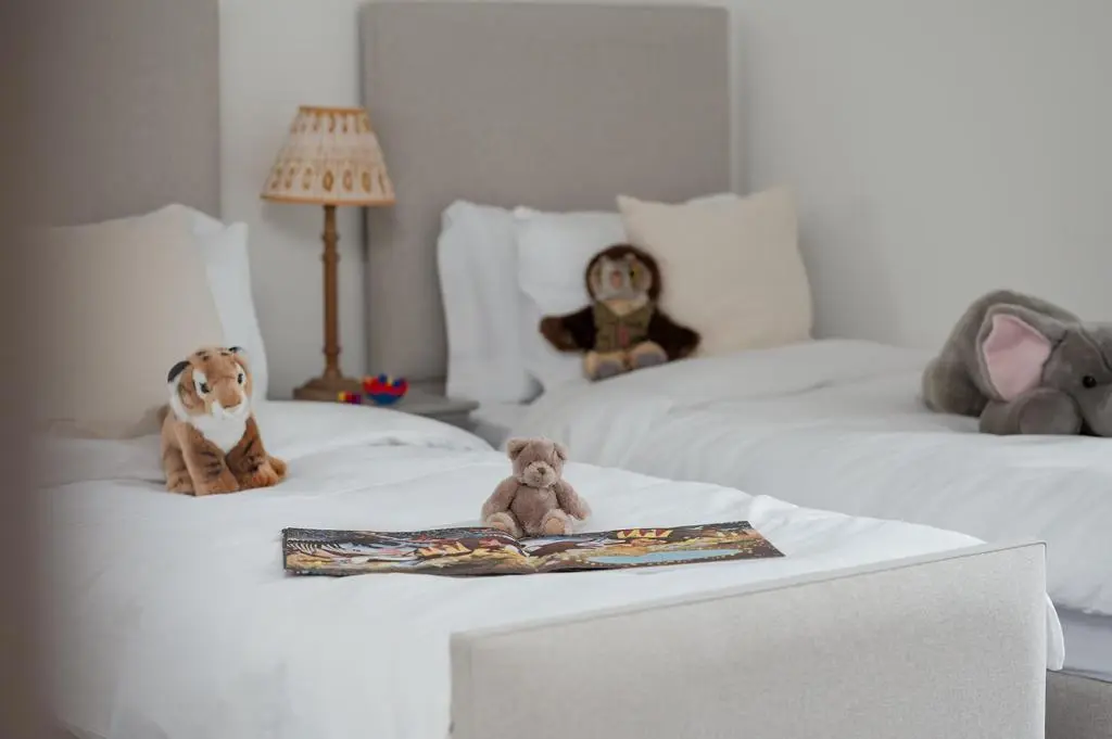 two stuffed animals are sitting on two beds at Osprey's Nest - Seasgair Lodges in Broomhill Station