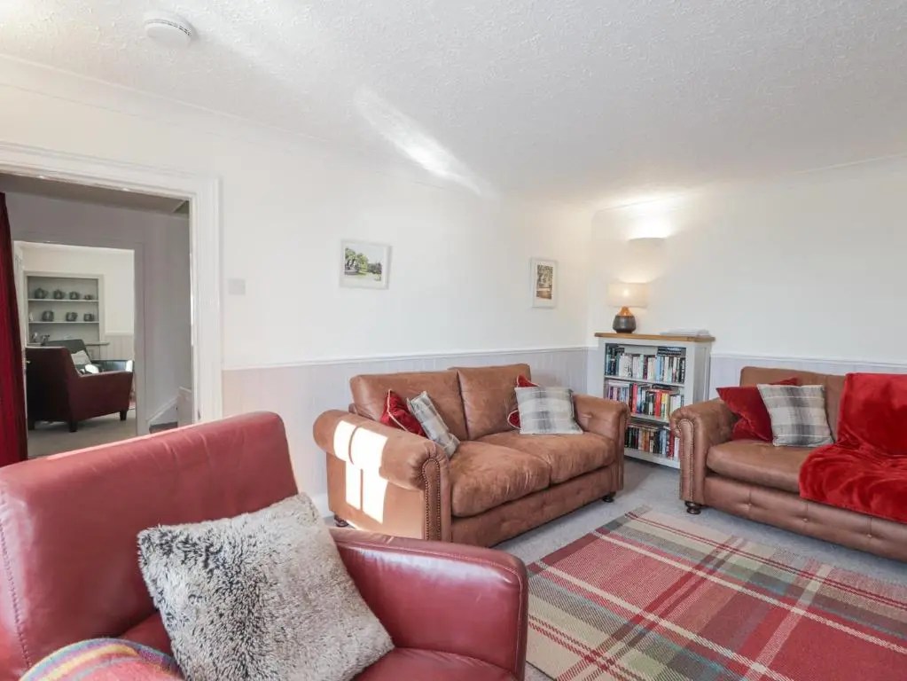 a living room with two couches and a couch at Fuchsia Cottage in Fortrose
