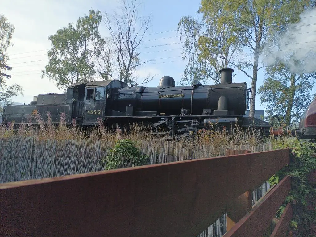 a black train is sitting on the tracks at Steam Train Cottage in Aviemore