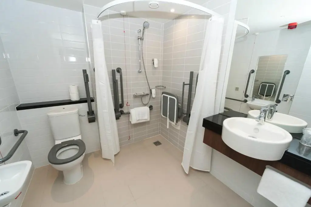 a bathroom with a toilet and a sink and a shower at Holiday Inn Express Aberdeen Airport by IHG in Dyce