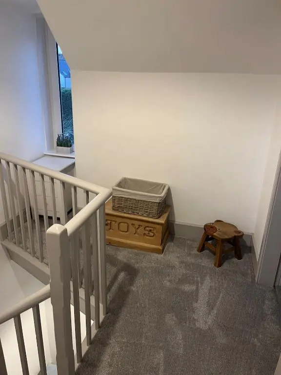a room with a staircase with a box on the floor at Willow's Cottage in Auldearn
