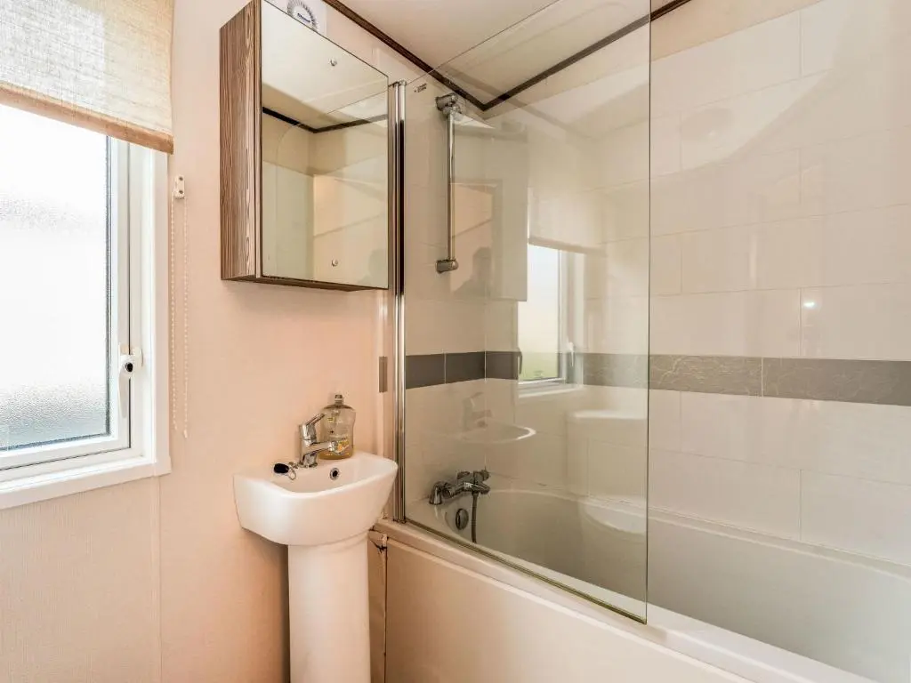 a bathroom with a sink and a shower and a toilet at Chalet Monarch by Interhome in Aviemore