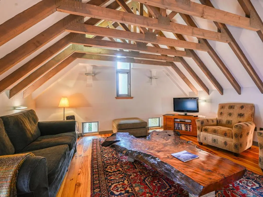 a living room with a couch and a table at Holiday Home Loch Ness Granary by Interhome in Invermoriston