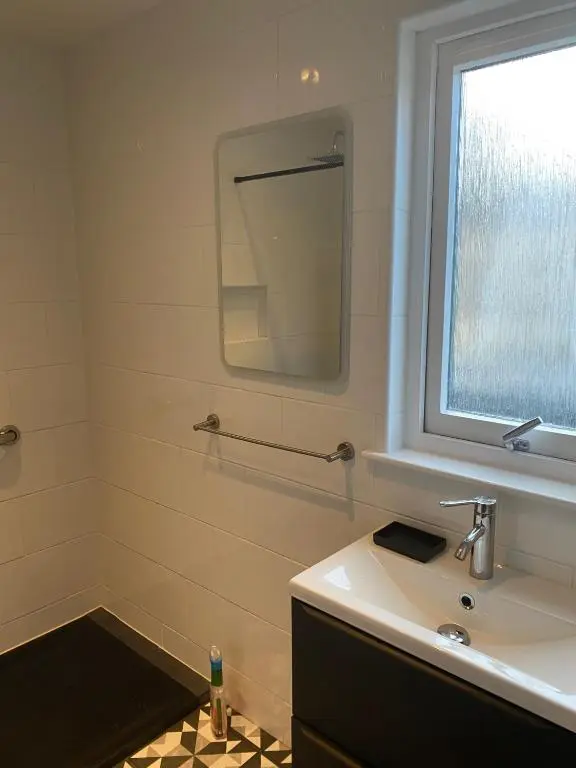 a bathroom with a sink and a mirror at 4guests-2br-privategarden-freeparking in Aviemore