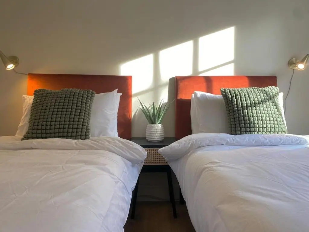 two beds sitting next to each other in a bedroom at Warm, stylish 2-bed in Crown, Inverness in Inverness