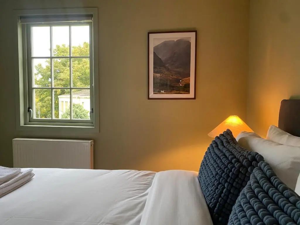 a bedroom with a bed and a window at Warm, stylish 2-bed in Crown, Inverness in Inverness