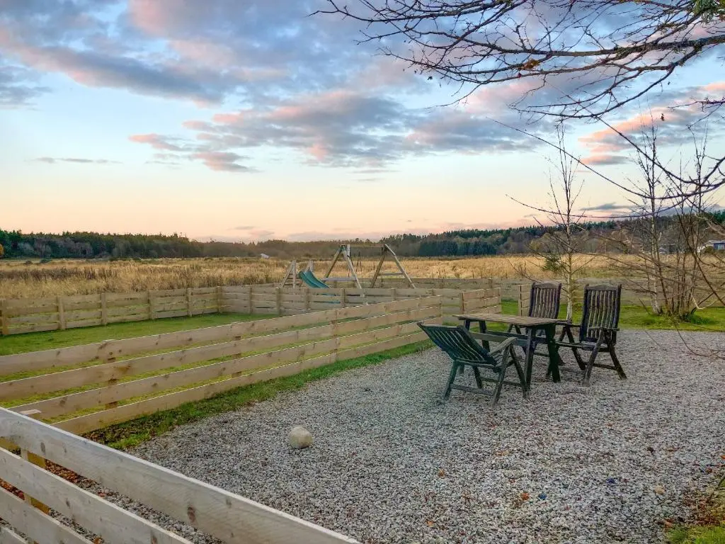 a picnic table with two chairs and a playground at The Kestrel - Ukc6920 in Forres