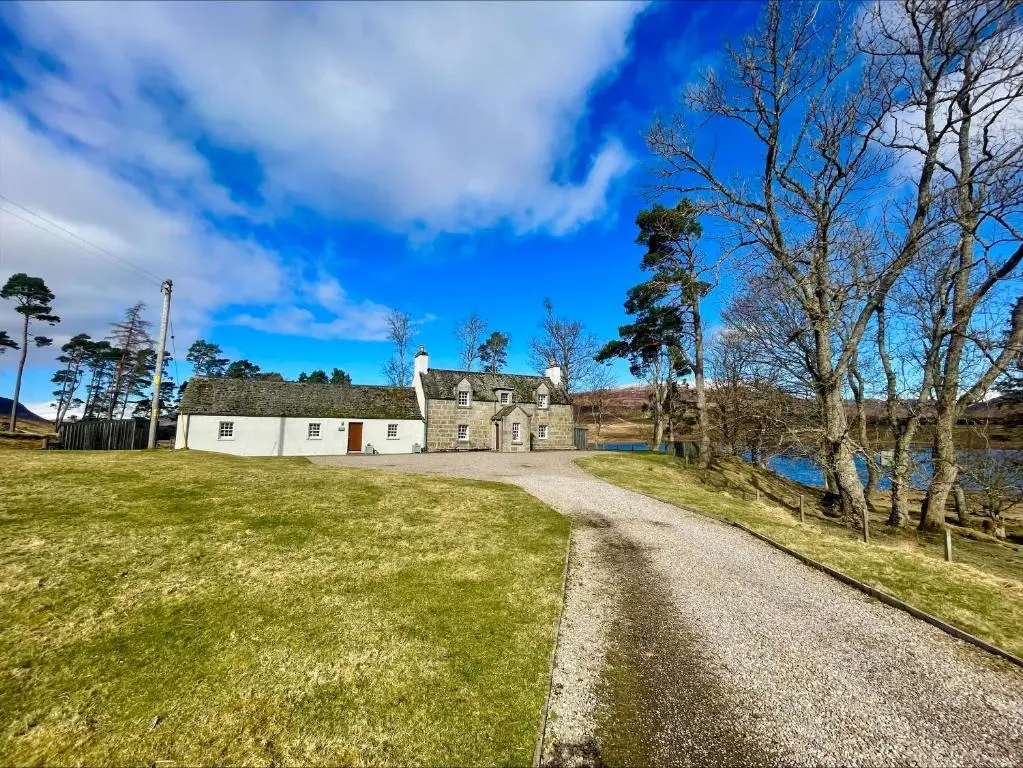 an old house on the side of a road at Sherrabeg Cottage in Laggan