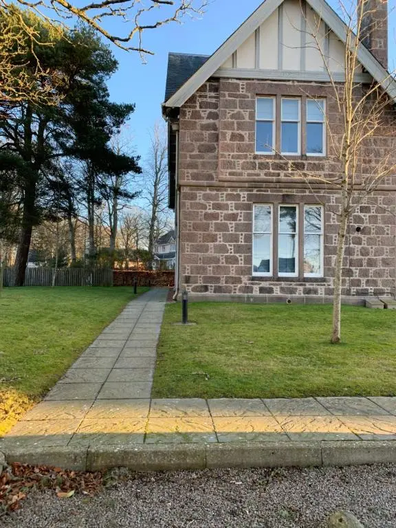 a brick house with a sidewalk in front of it at Junique Modern Ground Floor Apartment - 2 bedrooms in Aberdeen