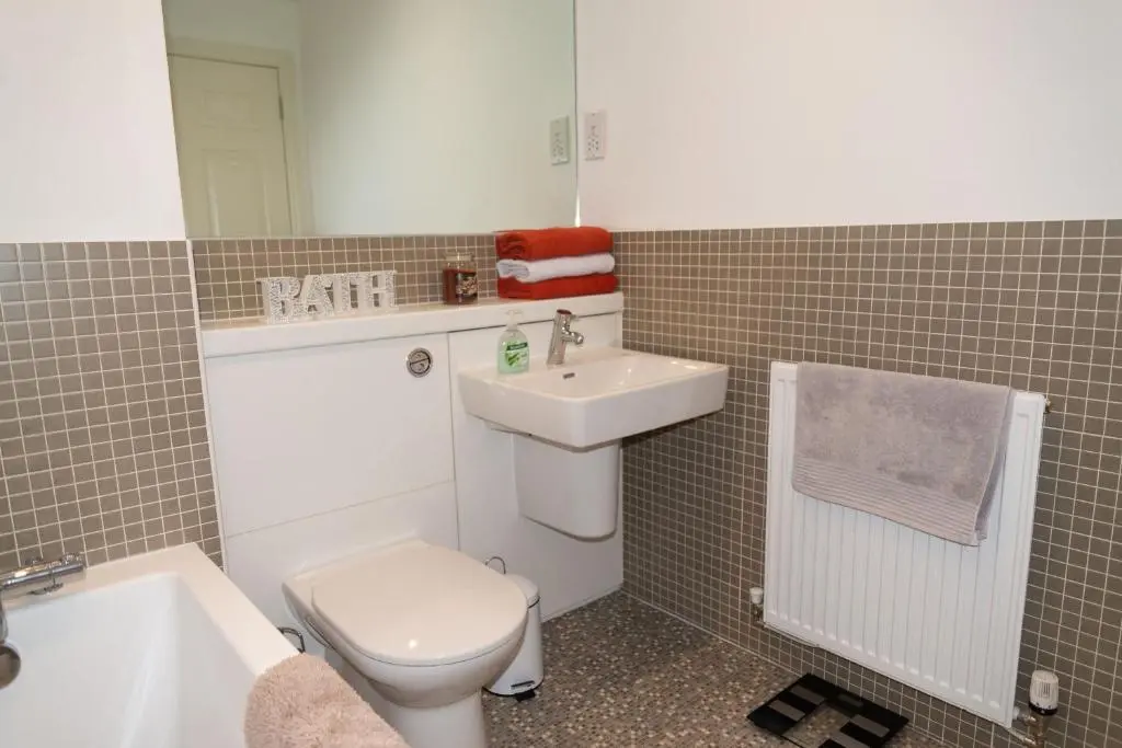 a bathroom with a toilet and a sink at Junique Modern Ground Floor Apartment - 2 bedrooms in Aberdeen