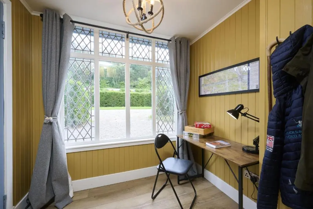 a room with a desk and a window at Garden Cottage in Inverness