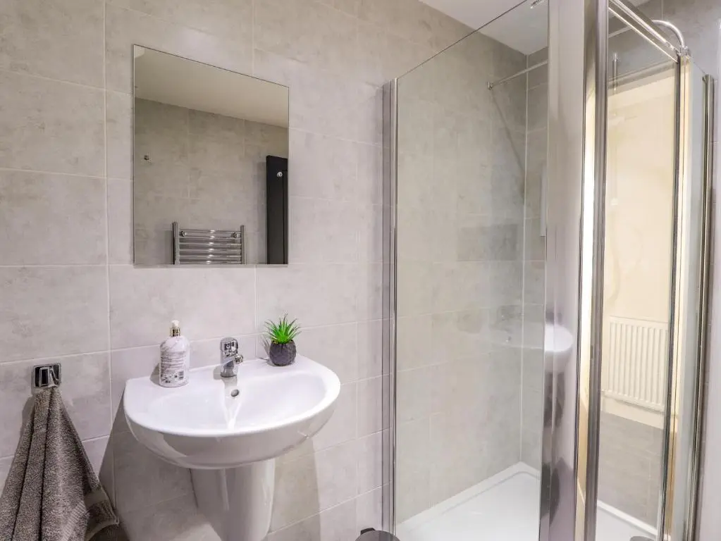 a bathroom with a sink and a shower at 3 The Granary in Banff