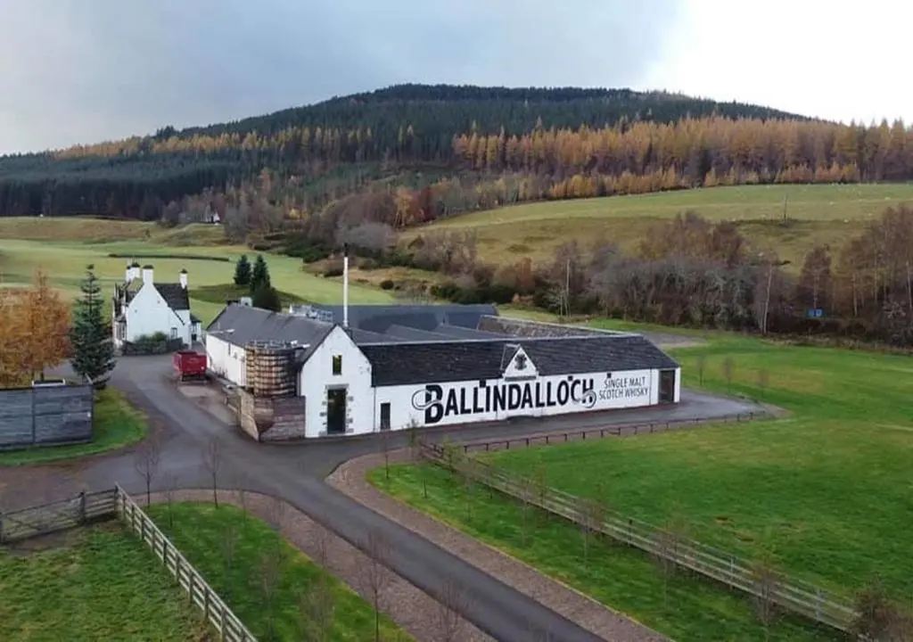 an aerial view of a building in a field at Swiss Cottage in Ballindalloch