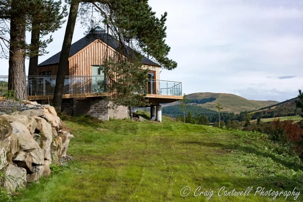 a house on the side of a hill at Dalnoid Cottages & Treehouses Nr Glenshee in Glenshee
