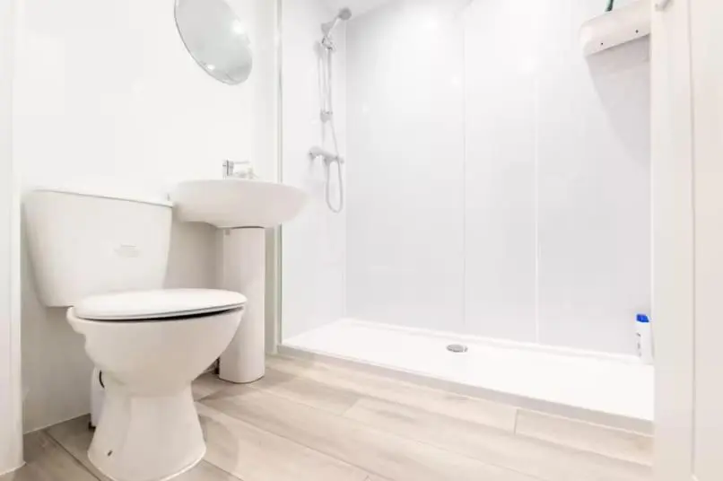 a white bathroom with a toilet and a sink at Charming City Centre Flat in Inverness