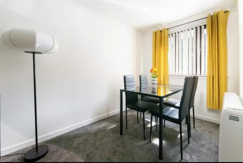 a dining room with a glass table and chairs at Charming City Centre Flat in Inverness