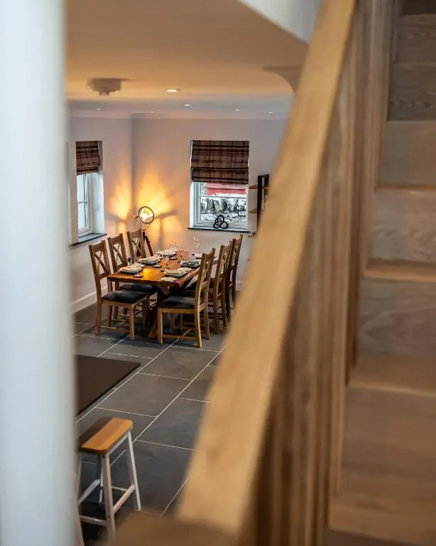 a dining room with a table and chairs at Holly Tree Cottage in Dornoch