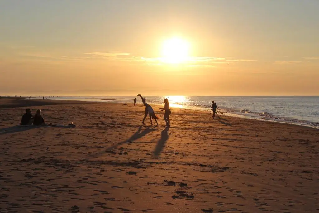 a group of people playing on the beach at sunset at Kirkton Cottage whole house in Cairnie Aberdeenshire in Rothiemay Station