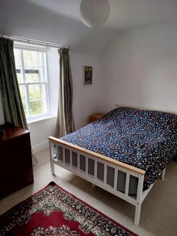 a bedroom with a bed in a room with a window at Kirkton Cottage whole house in Cairnie Aberdeenshire in Rothiemay Station