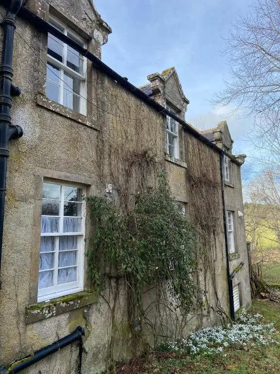 an old stone house with vines growing on it at Kirkton Cottage whole house in Cairnie Aberdeenshire in Rothiemay Station