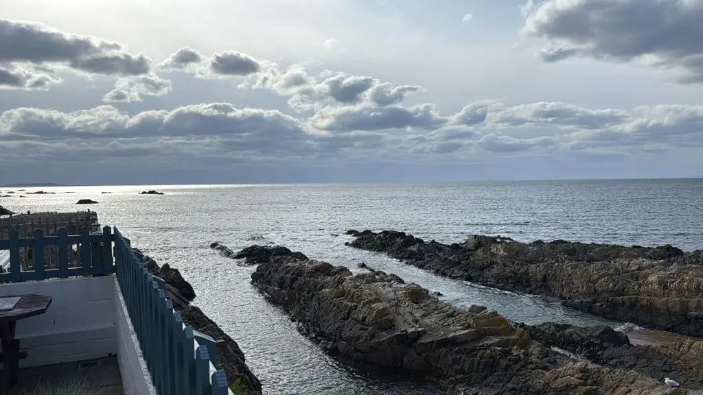 a view of the ocean with rocks in the water at Findochty Beach house - Private Garden-BeachFront in Buckie