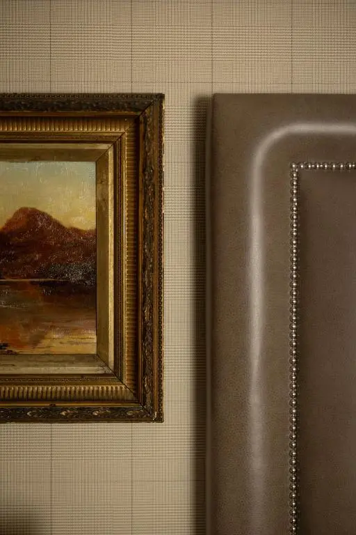 a picture of a painting on a wall next to a clipboard at The Station Hotel in Rothes