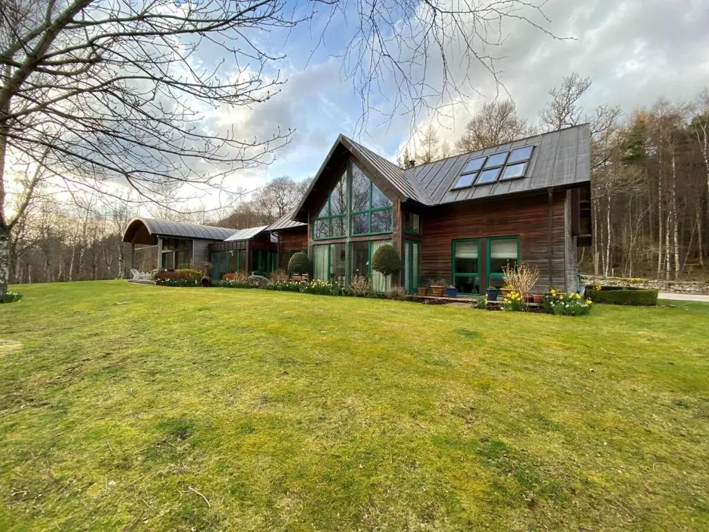 a house with a large lawn in front of it at Spacious, cosy 6 bedroom house which sleeps 11 in Banchory
