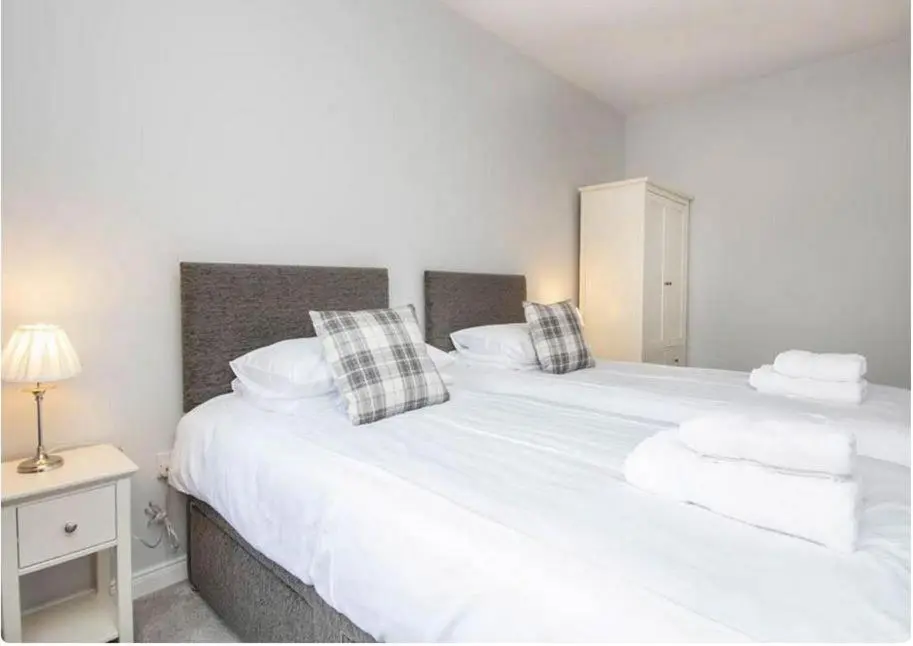 a bedroom with two beds with white sheets and pillows at 2 Bedroom Hedgefield Apartment 41-Free Parking in Inverness