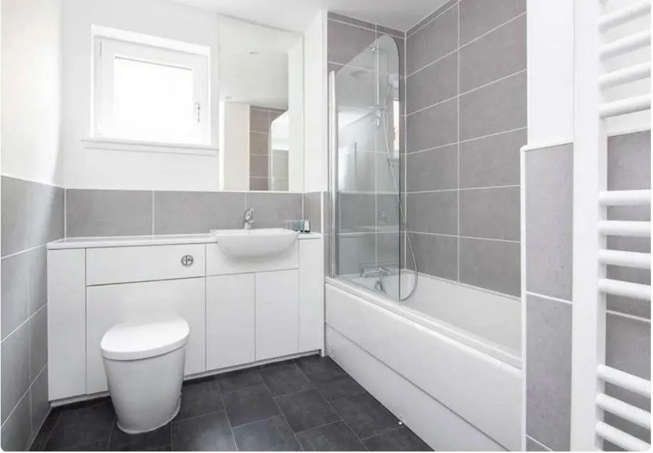 a white bathroom with a toilet and a sink at 2 Bedroom Hedgefield Apartment 41-Free Parking in Inverness