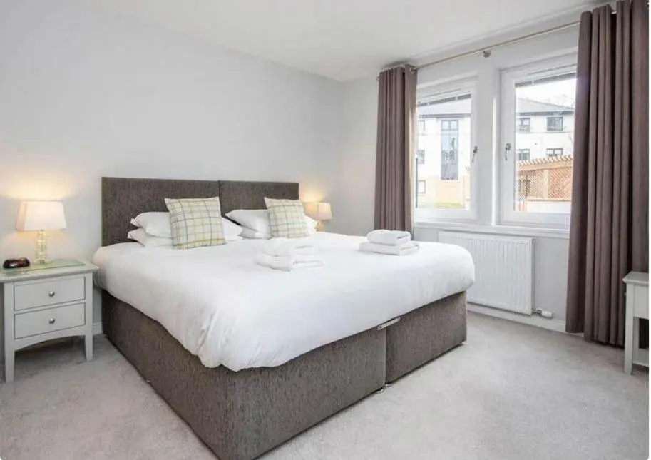 a bedroom with a large bed and a window at 2 Bedroom Hedgefield Apartment 41-Free Parking in Inverness