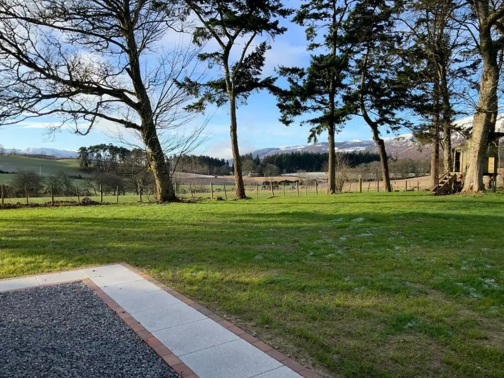 a park with trees and grass and a field at 3 Bed House near Loch Ness in Inverness