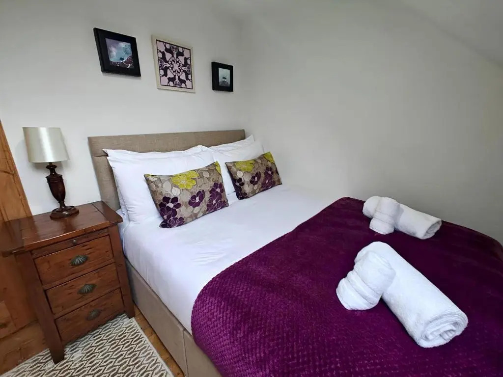 a bedroom with a bed with towels on it at 3 Bed in Aviemore oc-s30815 in Aviemore